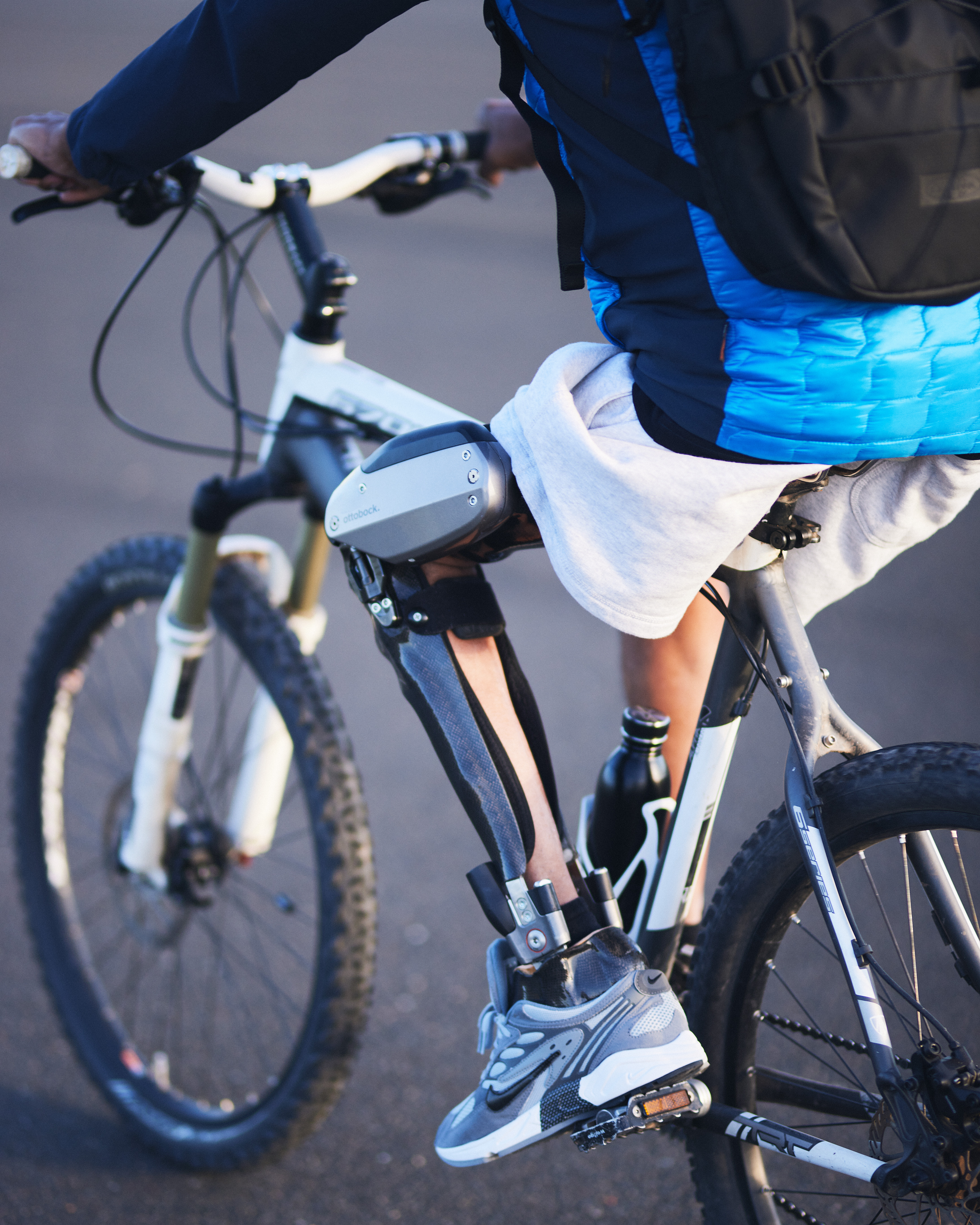 A knee ankle foot orthosis user riding their bicycle with the help of the C-Brace by Ottobock